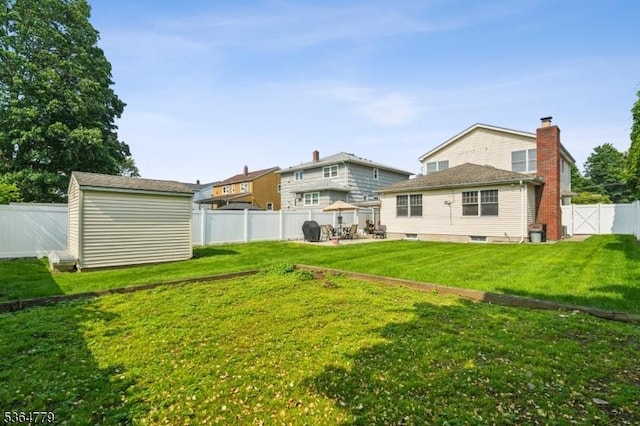 458 Midland Ave, Pompton Lakes Boro, NJ 07442 - rear view of house with a fenced backyard, a storage unit, and a patio area