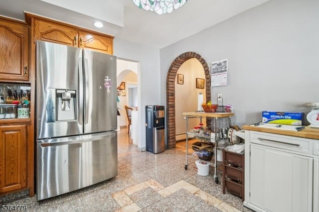 458 Midland Ave, Pompton Lakes Boro, NJ 07442 - kitchen featuring stainless steel refrigerator with ice dispenser, arched walkways, granite floors, brown cabinetry, and recessed lighting
