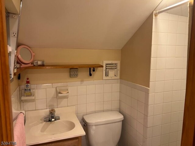 797 Chestnut St, Union Twp, NJ 07083 - bathroom with lofted ceiling, vanity, tile walls, and wainscoting