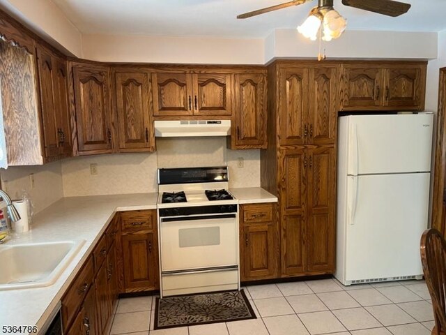 797 Chestnut St, Union Twp, NJ 07083 - kitchen with white appliances, under cabinet range hood, ceiling fan, and light countertops
