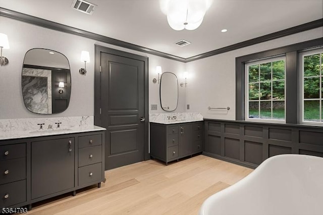 171 Campbell Rd, Bernardsville Boro, NJ 07924 - full bathroom featuring ornamental molding, wood finished floors, two vanities, and a freestanding bath