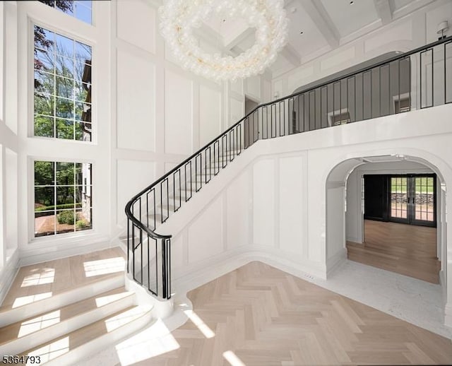 171 Campbell Rd, Bernardsville Boro, NJ 07924 - stairs with a high ceiling, arched walkways, a decorative wall, and french doors