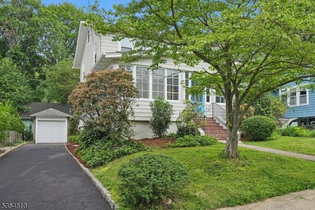 26 Saint Lawrence Ave, Maplewood Twp, NJ 07040 - view of property hidden behind natural elements with asphalt driveway, a garage, and a front lawn