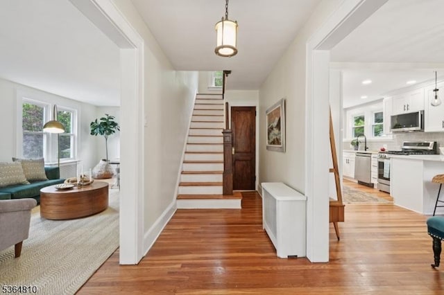 26 Saint Lawrence Ave, Maplewood Twp, NJ 07040 - foyer featuring light wood-type flooring, stairway, and plenty of natural light