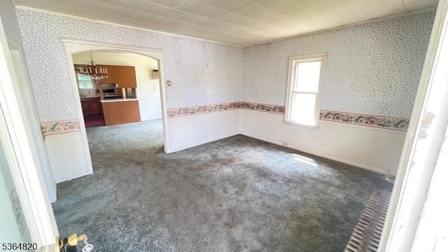 34 School St, North Haledon Boro, NJ 07508 - spare room with wallpapered walls, arched walkways, carpet, and a chandelier