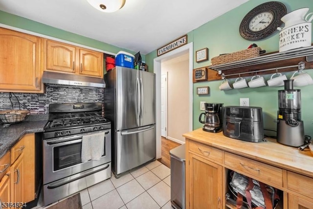 510 Oakridge Ave, North Plainfield Boro, NJ 07063 - kitchen with under cabinet range hood, appliances with stainless steel finishes, light tile patterned floors, and decorative backsplash