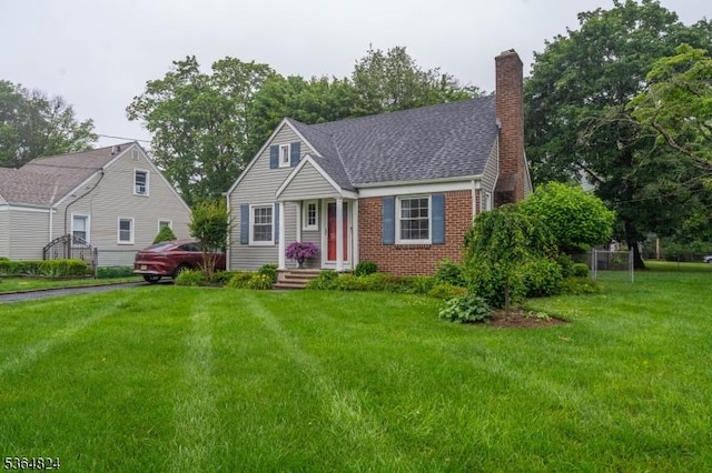 510 Oakridge Ave, North Plainfield Boro, NJ 07063 - cape cod house featuring a front yard, a chimney, and brick siding