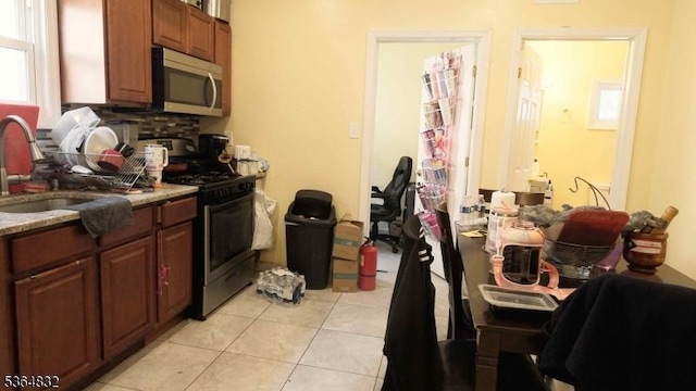 1371 Clinton Ave, Irvington Twp, NJ 07111 - kitchen with stainless steel appliances, light tile patterned floors, tasteful backsplash, and light countertops