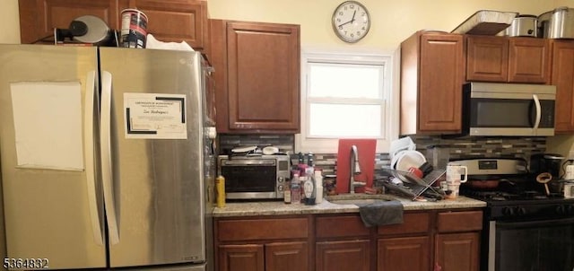 1371 Clinton Ave, Irvington Twp, NJ 07111 - kitchen featuring stainless steel appliances, backsplash, and brown cabinets