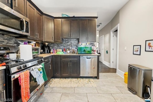 29 Pitt St, Bloomfield Twp, NJ 07003 - kitchen featuring stainless steel appliances, tasteful backsplash, light countertops, and dark brown cabinets