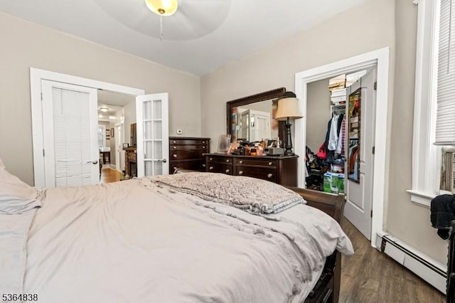29 Pitt St, Bloomfield Twp, NJ 07003 - bedroom featuring baseboard heating, dark wood-style flooring, a closet, a spacious closet, and ceiling fan