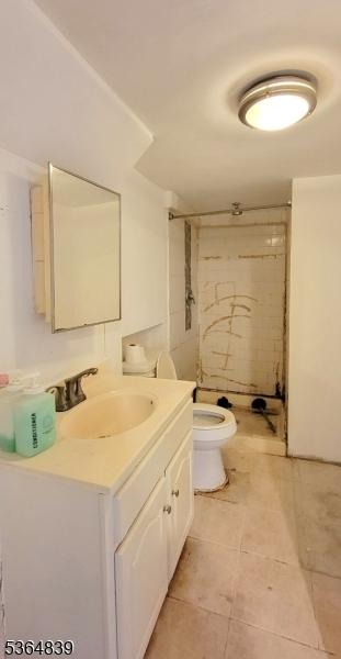 209 Sylvan Ave, Newark City, NJ 07104 - bathroom featuring vanity, a stall shower, and tile patterned floors