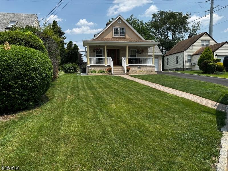 192 Beech St, Belleville Twp, NJ 07109 - bungalow-style house featuring a porch, a front yard, and a garage