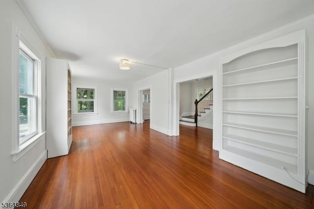 9 Vincent Pl, Montclair Twp, NJ 07042 - unfurnished living room with stairway, built in shelves, and wood finished floors