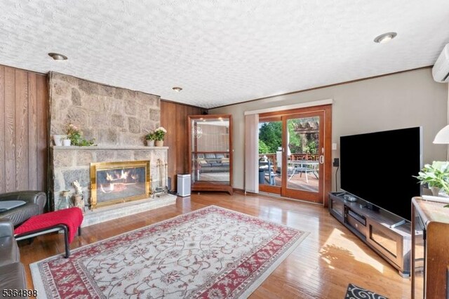 1221 Kelly St, Union Twp, NJ 07083 - living area featuring wood walls, a fireplace, and wood finished floors
