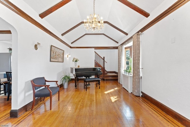 1221 Kelly St, Union Twp, NJ 07083 - living area featuring light wood finished floors, a chandelier, stairway, and arched walkways