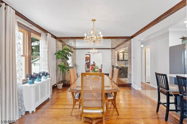 1221 Kelly St, Union Twp, NJ 07083 - dining room featuring radiator, a chandelier, light wood-style flooring, and crown molding