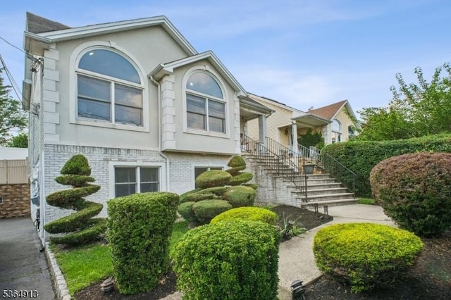 286 Meadow Rd Unit Rt17, Serv Rutherford Boro, NJ 07070 - view of front of house featuring stucco siding, brick siding, and stairway