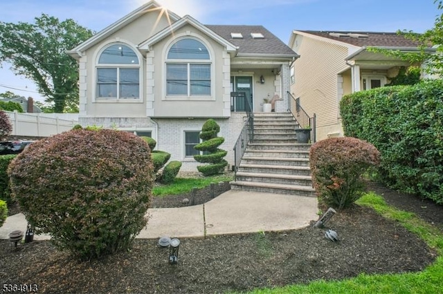 286 Meadow Rd Unit Rt17, Serv Rutherford Boro, NJ 07070 - view of front of home with stairway, brick siding, stucco siding, and roof with shingles