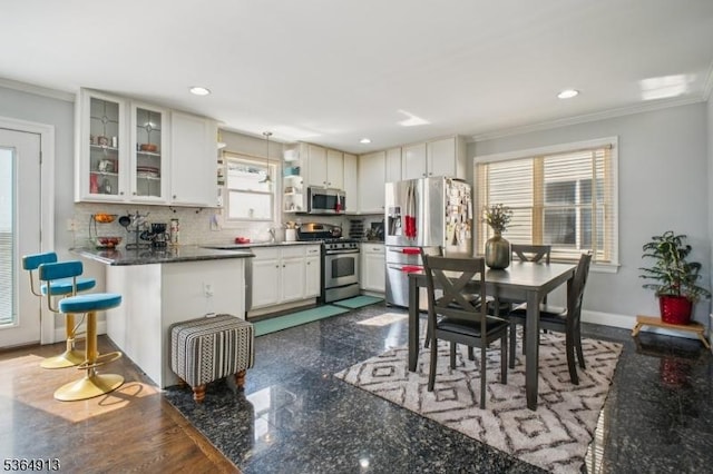 286 Meadow Rd Unit Rt17, Serv Rutherford Boro, NJ 07070 - kitchen featuring stainless steel appliances, ornamental molding, backsplash, glass insert cabinets, and recessed lighting