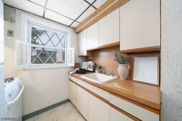 317 Stevens Ave, Jersey City, NJ 07305 - kitchen featuring white range, white cabinets, light countertops, and light flooring