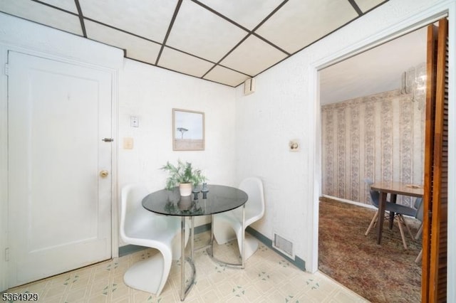 317 Stevens Ave, Jersey City, NJ 07305 - dining area featuring wallpapered walls, tile patterned floors, and a paneled ceiling