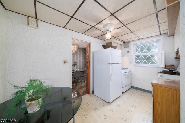 317 Stevens Ave, Jersey City, NJ 07305 - kitchen with white appliances, light flooring, and a paneled ceiling
