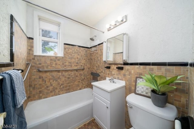 317 Stevens Ave, Jersey City, NJ 07305 - bathroom featuring vanity, tile walls, shower / tub combination, and a wainscoted wall
