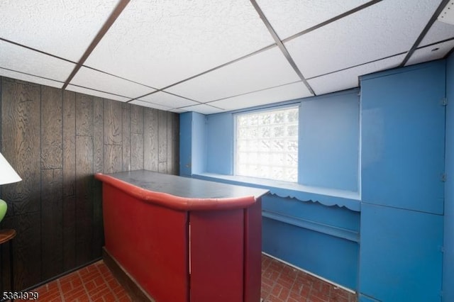 317 Stevens Ave, Jersey City, NJ 07305 - misc room with a drop ceiling, brick patterned floors, and wood walls