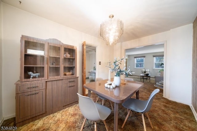 317 Stevens Ave, Jersey City, NJ 07305 - carpeted dining space with a chandelier and baseboards