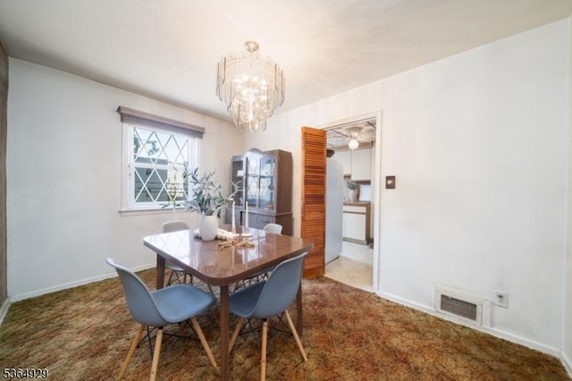 317 Stevens Ave, Jersey City, NJ 07305 - carpeted dining area with a chandelier and baseboards