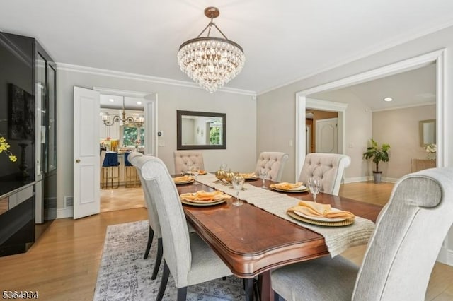 82 Mohawk Rd, Millburn Twp, NJ 07078 - dining area with a chandelier, light wood-style floors, crown molding, and recessed lighting