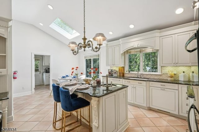 82 Mohawk Rd, Millburn Twp, NJ 07078 - kitchen with a skylight, plenty of natural light, decorative backsplash, light tile patterned floors, and recessed lighting