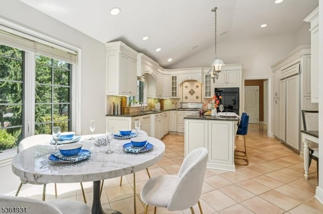 82 Mohawk Rd, Millburn Twp, NJ 07078 - kitchen featuring oven, backsplash, dark countertops, glass insert cabinets, and a center island