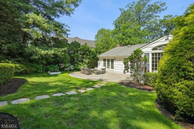 82 Mohawk Rd, Millburn Twp, NJ 07078 - view of green lawn with an outdoor hangout area, a patio, and french doors