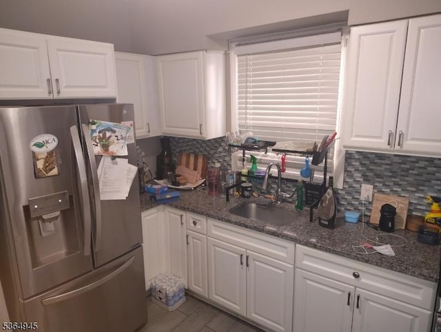 341 N Grove St, East Orange City, NJ 07017 - kitchen featuring stainless steel fridge, decorative backsplash, white cabinets, and dark stone countertops