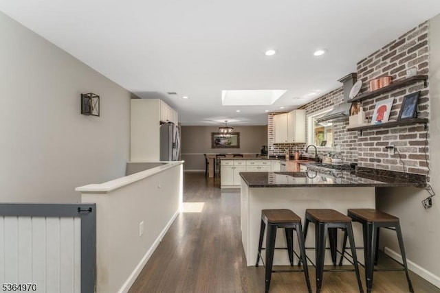 25 Old Turnpike Rd, Washington Twp, NJ 07865 - kitchen featuring a peninsula, freestanding refrigerator, a skylight, dark wood-style floors, and recessed lighting