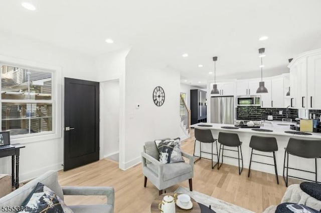 944 Orange Ave, Cranford Twp, NJ 07016 - living room featuring stairway, light wood-type flooring, and recessed lighting