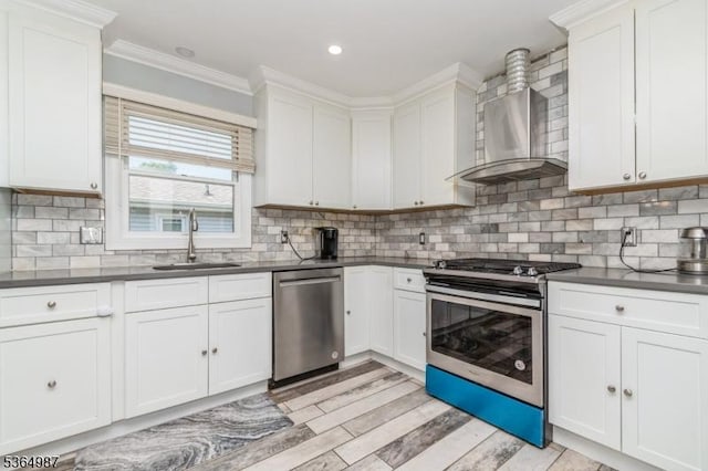 14 Lenox Ave, Green Brook Twp, NJ 08812 - kitchen featuring stainless steel appliances, wall chimney exhaust hood, crown molding, dark countertops, and white cabinetry