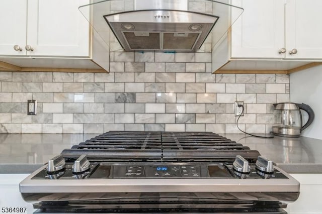 14 Lenox Ave, Green Brook Twp, NJ 08812 - kitchen view of extractor fan, black range with gas cooktop, white cabinetry, and decorative backsplash