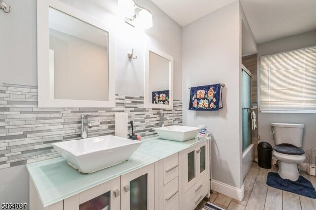 14 Lenox Ave, Green Brook Twp, NJ 08812 - bathroom with decorative backsplash, double vanity, combined bath / shower with glass door, and wood finished floors