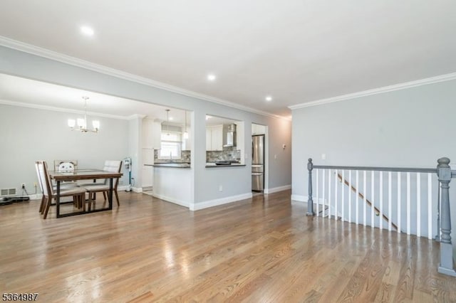 14 Lenox Ave, Green Brook Twp, NJ 08812 - living room featuring a chandelier, wood finished floors, crown molding, and recessed lighting
