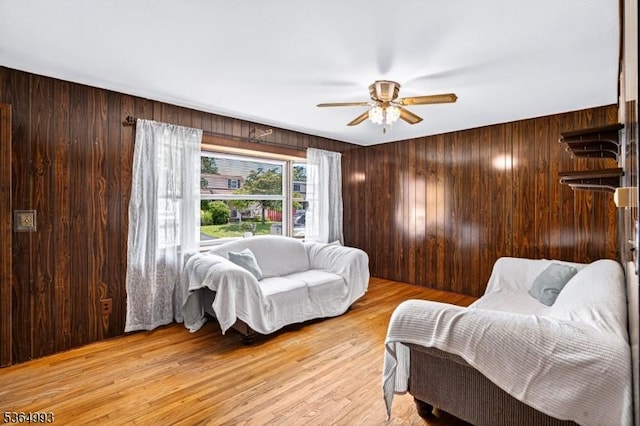 1033 Huff Ave, Manville Boro, NJ 08835 - living room with a ceiling fan, wood walls, and light wood-style flooring
