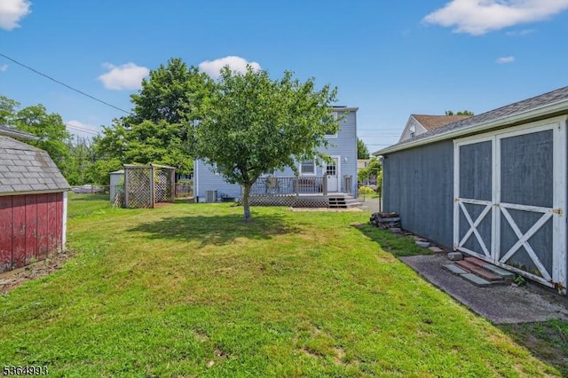 1033 Huff Ave, Manville Boro, NJ 08835 - view of grassy yard featuring a storage shed and a deck