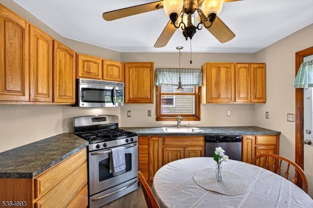 1033 Huff Ave, Manville Boro, NJ 08835 - kitchen with appliances with stainless steel finishes, a ceiling fan, dark countertops, and brown cabinets