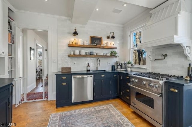 62 Mountain Ave, Summit City, NJ 07901 - kitchen featuring appliances with stainless steel finishes, dark countertops, blue cabinetry, decorative backsplash, and crown molding