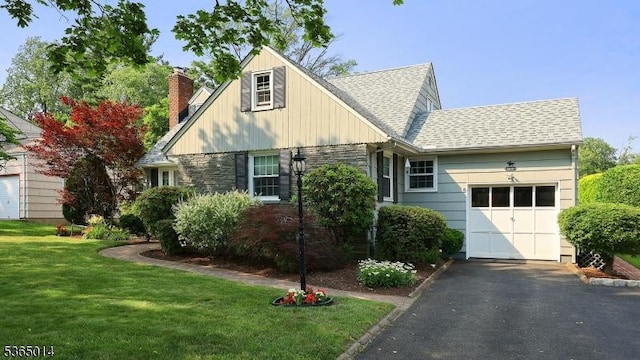 120 Meadowbrook Dr, North Plainfield Boro, NJ 07062 - view of front of house featuring an attached garage, driveway, a front lawn, a shingled roof, and a chimney