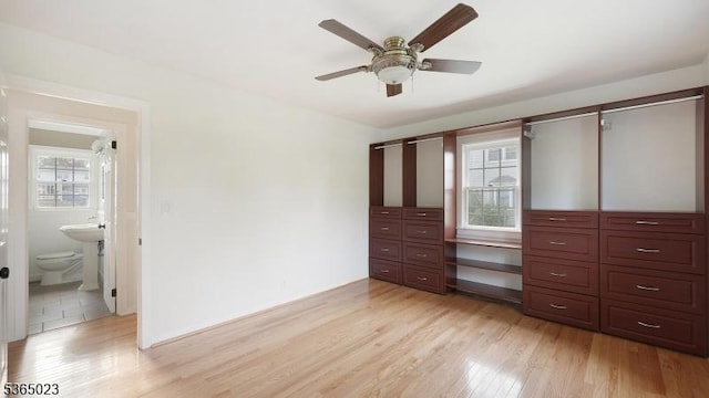 122 Madison St, South Bound Brook Boro, NJ 08880 - unfurnished bedroom featuring multiple windows, an office area, light wood finished floors, and connected bathroom