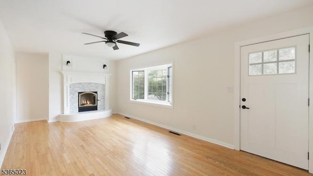 122 Madison St, South Bound Brook Boro, NJ 08880 - unfurnished living room with light wood-style flooring, a ceiling fan, and a stone fireplace