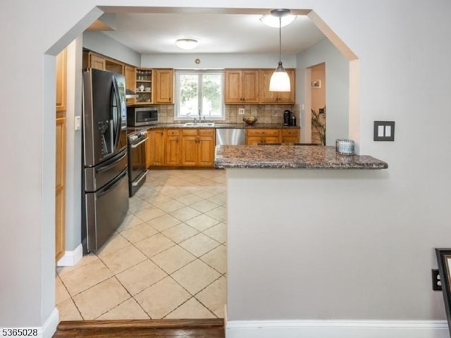 16 Seneca Trl, Randolph Twp, NJ 07869 - kitchen featuring stainless steel appliances, tasteful backsplash, dark stone countertops, a peninsula, and brown cabinetry